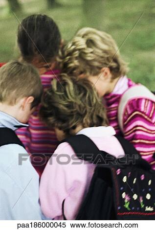 Children huddling, outdoors View Large Photo Image Stock Photography - Children huddling, outdoors. Fotosearch