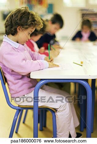Stock Photograph - Children in classroom, side view. Fotosearch
