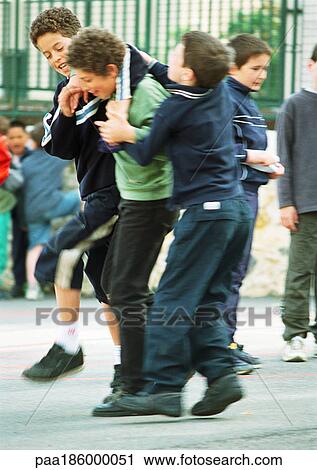 Children playfighting in schoolyard View Large Photo Image Stock Image - Children playfighting in schoolyard. Fotosearch