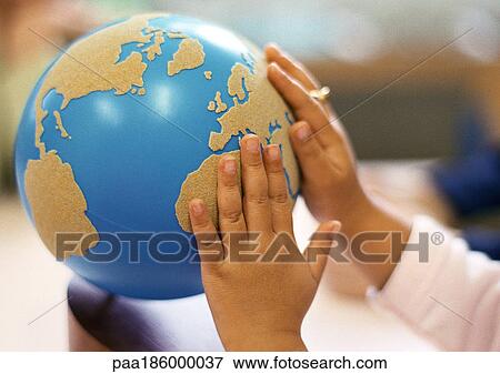 Child's hands on globe View Large Photo Image Stock Photo - Child's hands on globe. Fotosearch