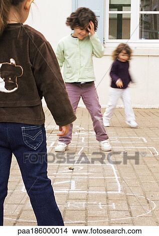 Three children playing hopscotch View Large Photo Image Picture - Three children playing hopscotch. Fotosearch