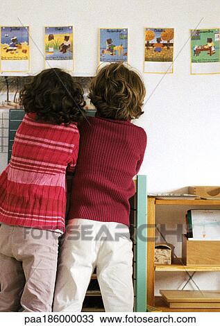 Stock Image - Two children side by side, rear view. Fotosearch