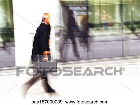 Businessman holding briefcase, blurred View Large Photo Image Stock Photo - Businessman holding briefcase, blurred. Fotosearch
