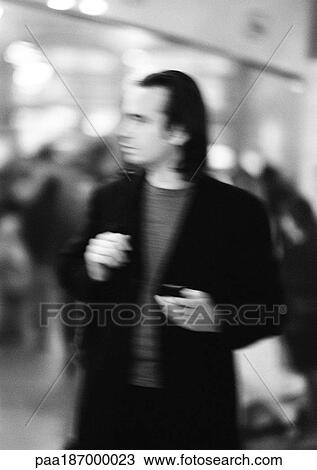 Businessman holding cell phone, blurred, b&w View Large Photo Image Stock Image - Businessman holding cell phone, blurred, b&w. Fotosearch
