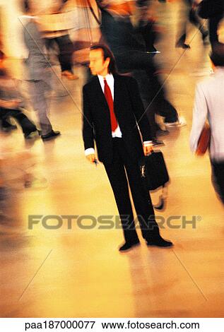 Businessman in crowd, blurred motion View Large Photo Image Stock Photo - Businessman in crowd, blurred motion. Fotosearch