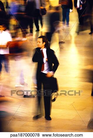 Businessman in crowd, blurred motion View Large Photo Image Stock Photo - Businessman in crowd, blurred motion. Fotosearch
