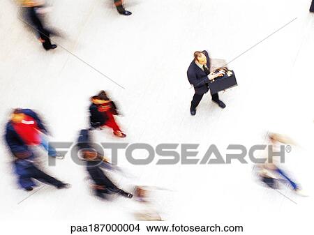 Businessman in crowd, elevated view, blurred View Large Photo Image Picture - Businessman in crowd, elevated view, blurred. Fotosearch