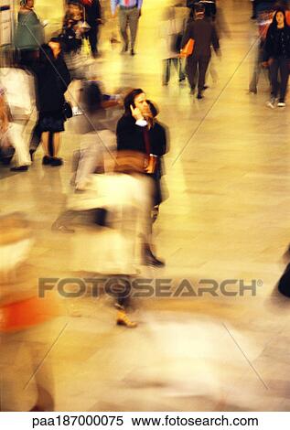 Businessman in crowd, using cell phone, blurred View Large Photo Image Stock Photography - Businessman in crowd, using cell phone, blurred. Fotosearch