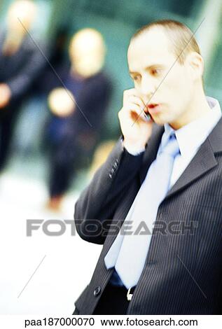 Businessman using cell phone, side view View Large Photo Image Stock Image - Businessman using cell phone, side view. Fotosearch
