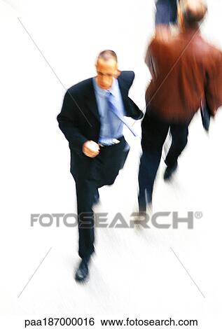 Businessman walking, elevated view, blurred View Large Photo Image Stock Photograph - Businessman walking, elevated view, blurred. Fotosearch