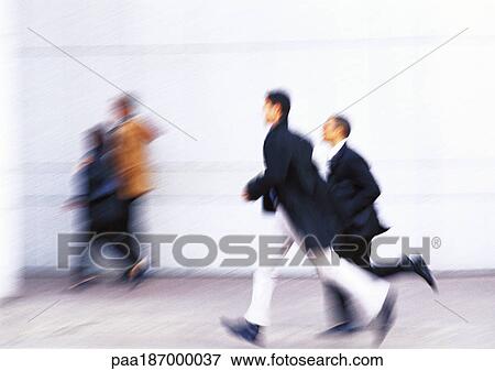 Stock Photo - Businessmen running, full length, side view, blurred. Fotosearch