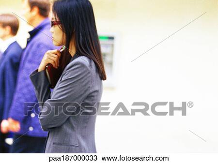 Businesswoman holding book, side view View Large Photo Image Stock Image - Businesswoman holding book, side view. Fotosearch