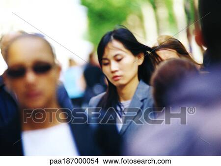 Businesswoman in crowd, head and shoulders, blurred View Large Photo Image Picture - Businesswoman in crowd, head and shoulders, blurred. Fotosearch
