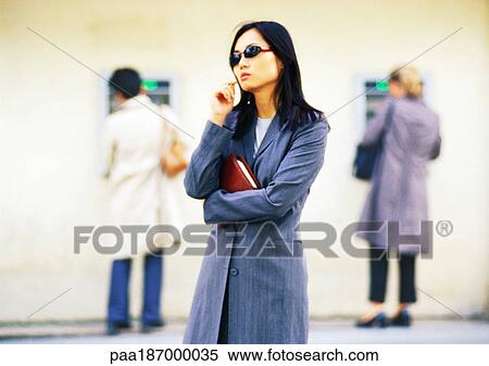 Businesswoman in front of cash machines View Large Photo Image Stock Photography - Businesswoman in front of cash machines. Fotosearch