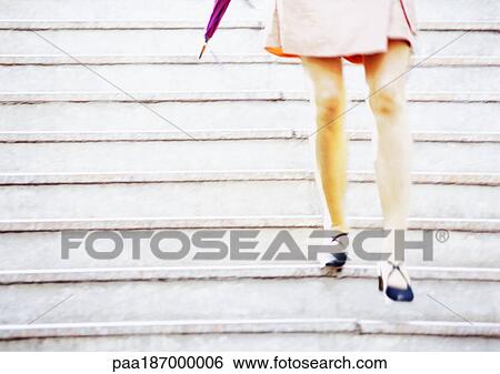 Stock Photograph - Businesswoman on stairs, low section. Fotosearch