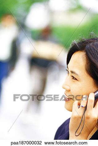 Businesswoman using cell phone, close-up, blurred background View Large Photo Image Stock Image - Businesswoman using cell phone, close-up, blurred background. Fotosearch