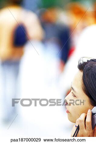 Businesswoman using cell phone, close-up, blurred background View Large Photo Image Stock Photo - Businesswoman using cell phone, close-up, blurred background. Fotosearch
