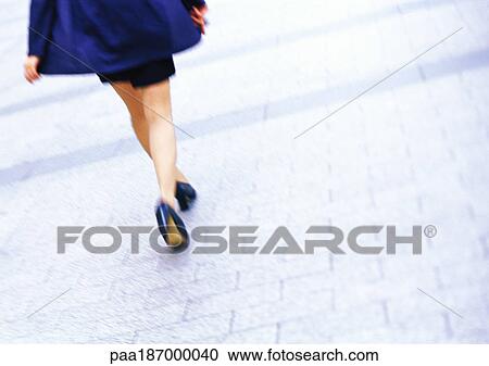 Businesswoman walking, low section, tilt, blurred motion View Large Photo Image Stock Image - Businesswoman walking, low section, tilt, blurred motion. Fotosearch