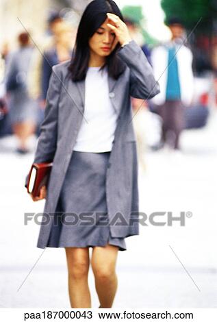Businesswoman walking with book in hand View Large Photo Image Stock Image - Businesswoman walking with book in hand. Fotosearch