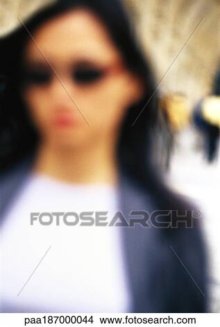 Businesswoman wearing sunglasses, close-up, blurred View Large Photo Image Picture - Businesswoman wearing sunglasses, close-up, blurred. Fotosearch