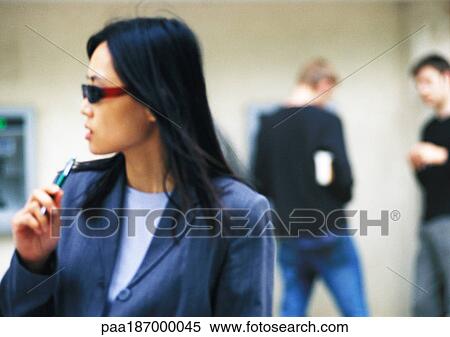 Businesswoman wearing sunglasses, holding pen View Large Photo Image Stock Photography - Businesswoman wearing sunglasses, holding pen. Fotosearch