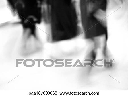 Stock Photo - People walking, low section, blurred, b&w. Fotosearch