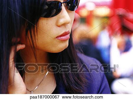 Woman wearing sunglasses, close-up View Large Photo Image Stock Photo - Woman wearing sunglasses, close-up. Fotosearch