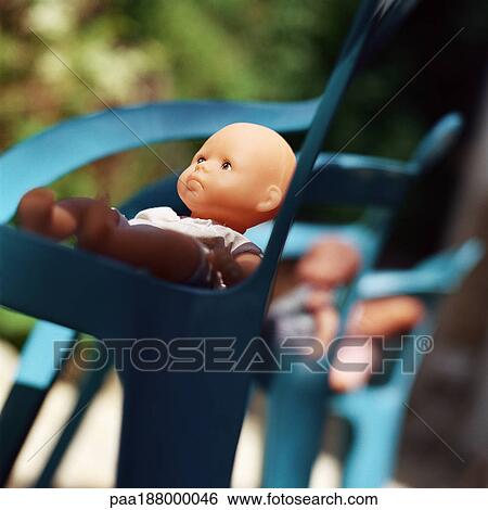 Baby dolls sitting in chairs. View Large Photo Image Stock Photograph - Baby dolls sitting in chairs.. Fotosearch
