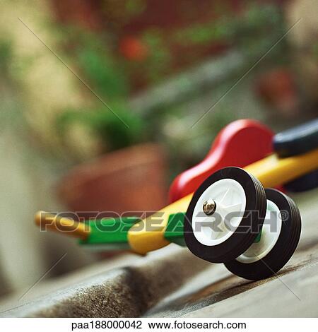 Child's toy scooter leaning on step. View Large Photo Image Stock Image - Child's toy scooter leaning on step.. Fotosearch