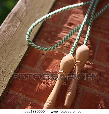Jump rope hanging on brick wall. View Large Photo Image Picture - Jump rope hanging on brick wall.. Fotosearch