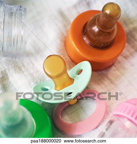 Pacifiers and baby bottle tops View Large Photo Image Stock Image - Pacifiers and baby bottle tops. Fotosearch