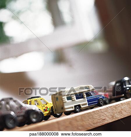 Toy Cars Lined Up On Table Stock Photo Paa Fotosearch