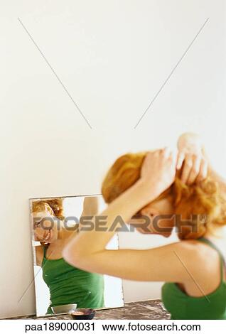 Woman looking at reflection in mirror. View Large Photo Image Stock Image - Woman looking at reflection in mirror.. Fotosearch
