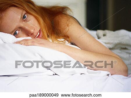 Woman lying on bed View Large Photo Image Stock Photo - Woman lying on bed. Fotosearch