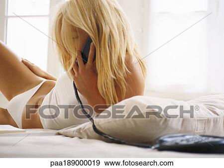 Woman on phone in bed. View Large Photo Image Stock Photo - Woman on phone in bed.. Fotosearch