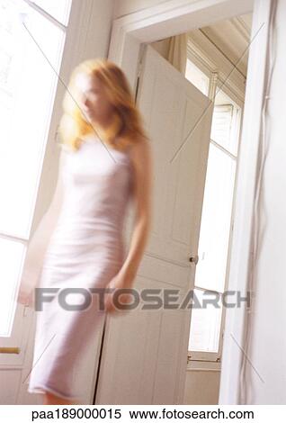 Woman walking through doorway, blurred. View Large Photo Image Stock Photography - Woman walking through doorway, blurred.. Fotosearch