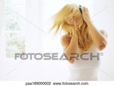 Woman with headphones on, shaking head, inside. View Large Photo Image Stock Image - Woman with headphones on, shaking head, inside.. Fotosearch
