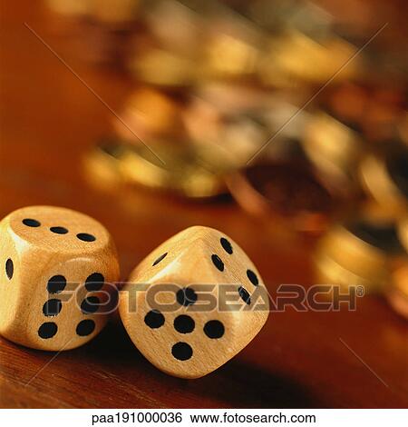 Dice in front of blurred pile of coins. View Large Photo Image Stock Photograph - Dice in front of blurred pile of coins.. Fotosearch