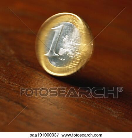 Euro coin rolling on table. View Large Photo Image Stock Photo - Euro coin rolling on table.. Fotosearch