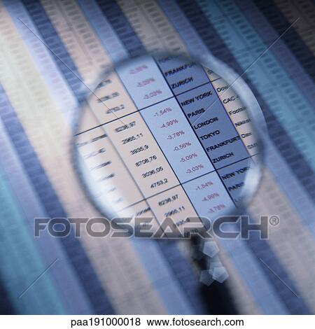 Magnifying glass over financial spreadsheet. View Large Photo Image Stock Photo - Magnifying glass over financial spreadsheet.. Fotosearch