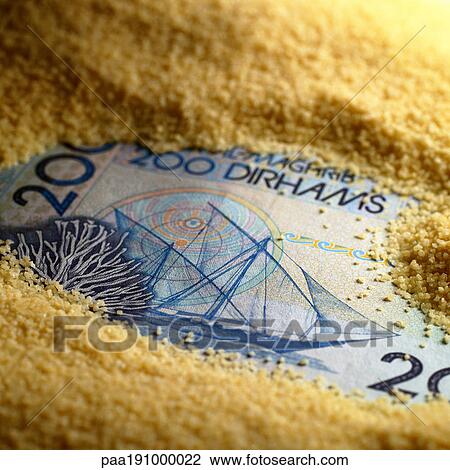 Stock Image - Moroccan money covered with couscous. Fotosearch
