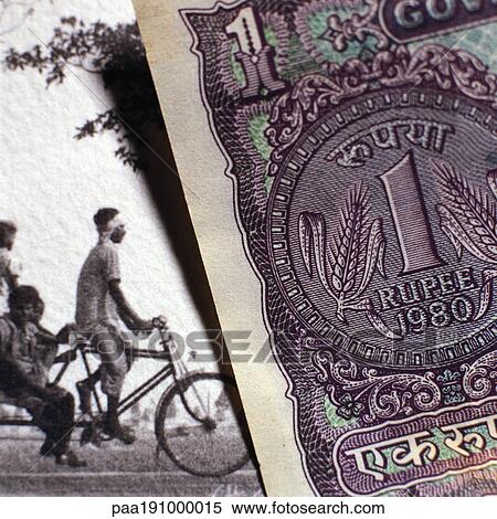 Stock Photography - Paper bill next to old photograph.. Fotosearch
