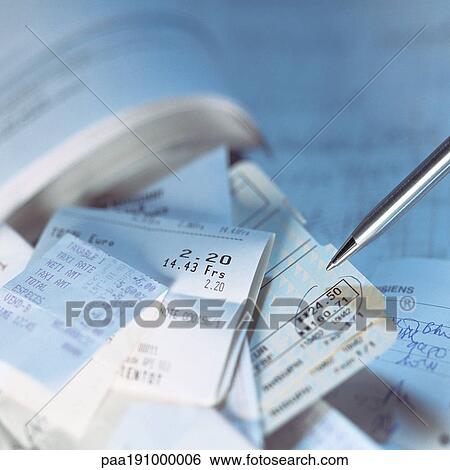 Stock Photograph - Pen above tickets and sales receipts.. Fotosearch