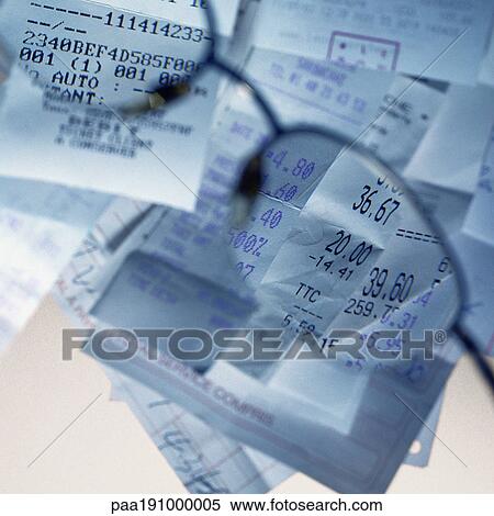 Stock Photography - Sales receipts viewed through glasses.. Fotosearch