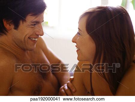 Man and woman smiling at each other, close-up View Large Photo Image Stock Image - Man and woman smiling at each other, close-up. Fotosearch