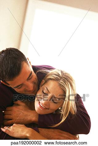 Man hugging woman from behind, head and shoulders, off centered, tilt View Large Photo Image Stock Image - Man hugging woman from behind, head and shoulders, off centered, tilt. Fotosearch