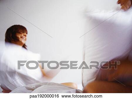 Woman and man having pillowfight, blurred. View Large Photo Image Stock Photograph - Woman and man having pillowfight, blurred.. Fotosearch
