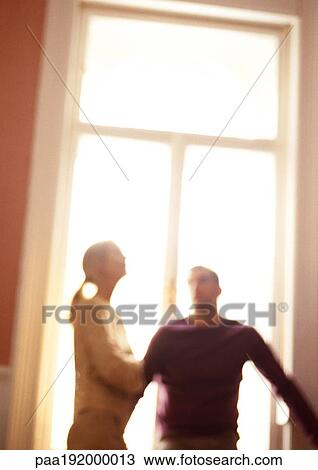 Woman and man standing in front of window, blurred, tilt. View Large Photo Image Stock Image - Woman and man standing in front of window, blurred, tilt.. Fotosearch