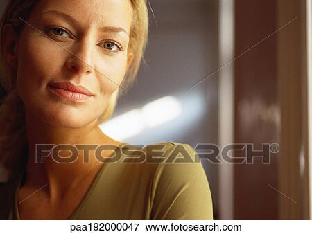 Stock Photo - Woman looking at camera, close-up, portrait.. Fotosearch