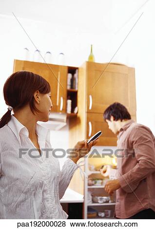 Woman looking at man in kitchen. View Large Photo Image Stock Photo - Woman looking at man in kitchen.. Fotosearch